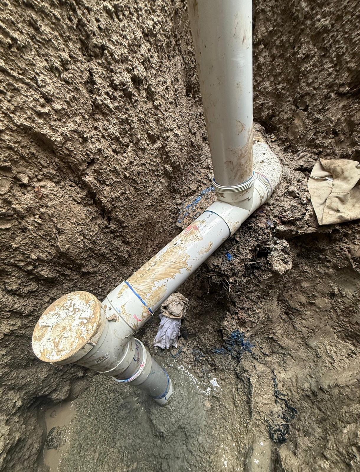 New PVC drain pipe laid in excavated trench alongside old pipe Mill Park Melbourne